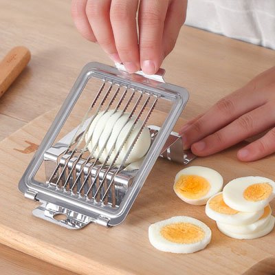 Coupe oeuf utilisé par une personne qui coupe en tranche des oeufs dures