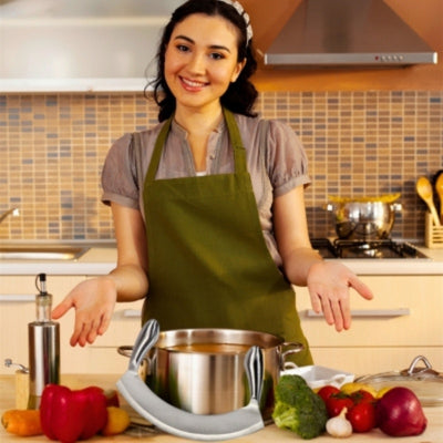 Femme souriante dans une cuisine devant un plan de travail sur lequel est posé une marmite, un couteau hachoir et des légumes