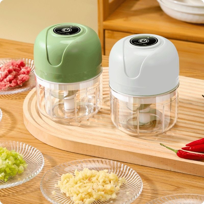 Hachoir électrique vert et blanc posés sur table