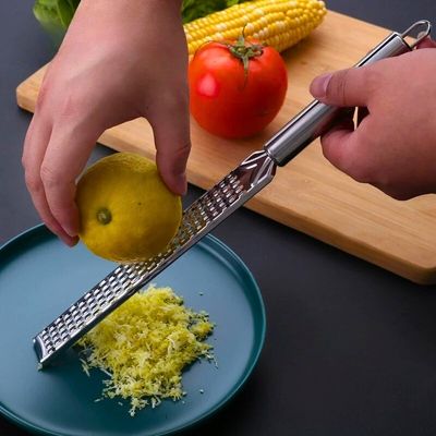 Personne utilisant une zesteur pour zester un citron